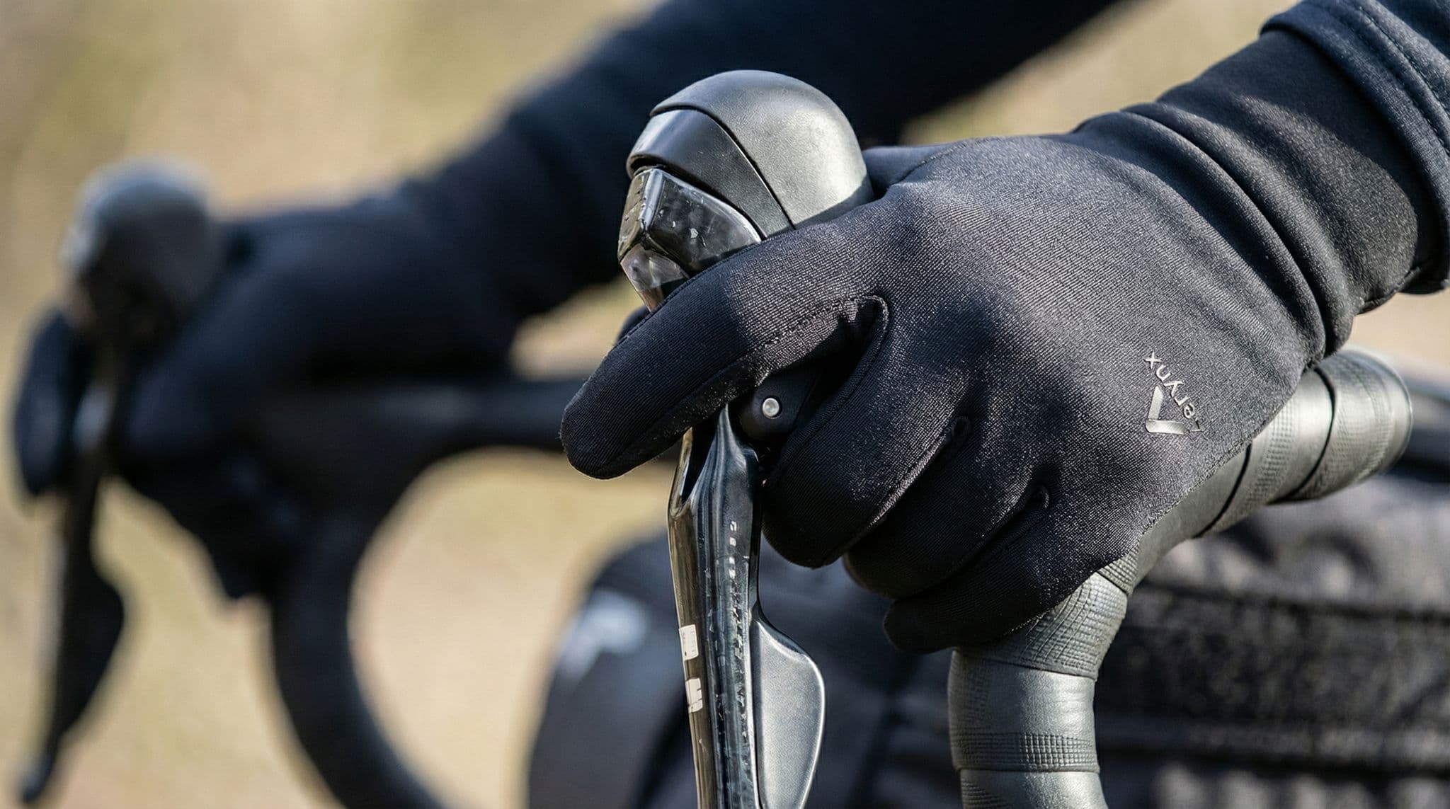 Aerynx X1 Lite gloves in an active cool-weather cycling scene